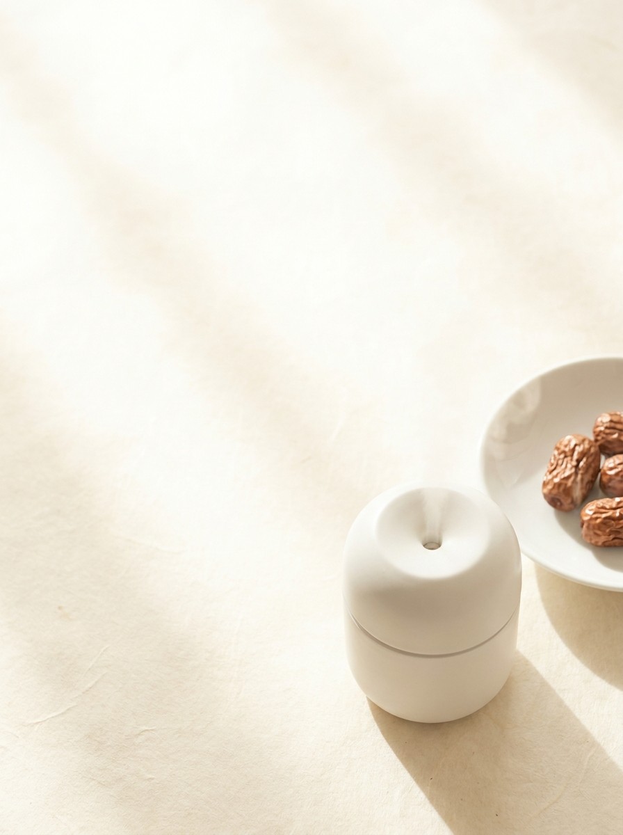 A soft natural-light still life with the props at the lower-right and bright empty space at the upper-left.